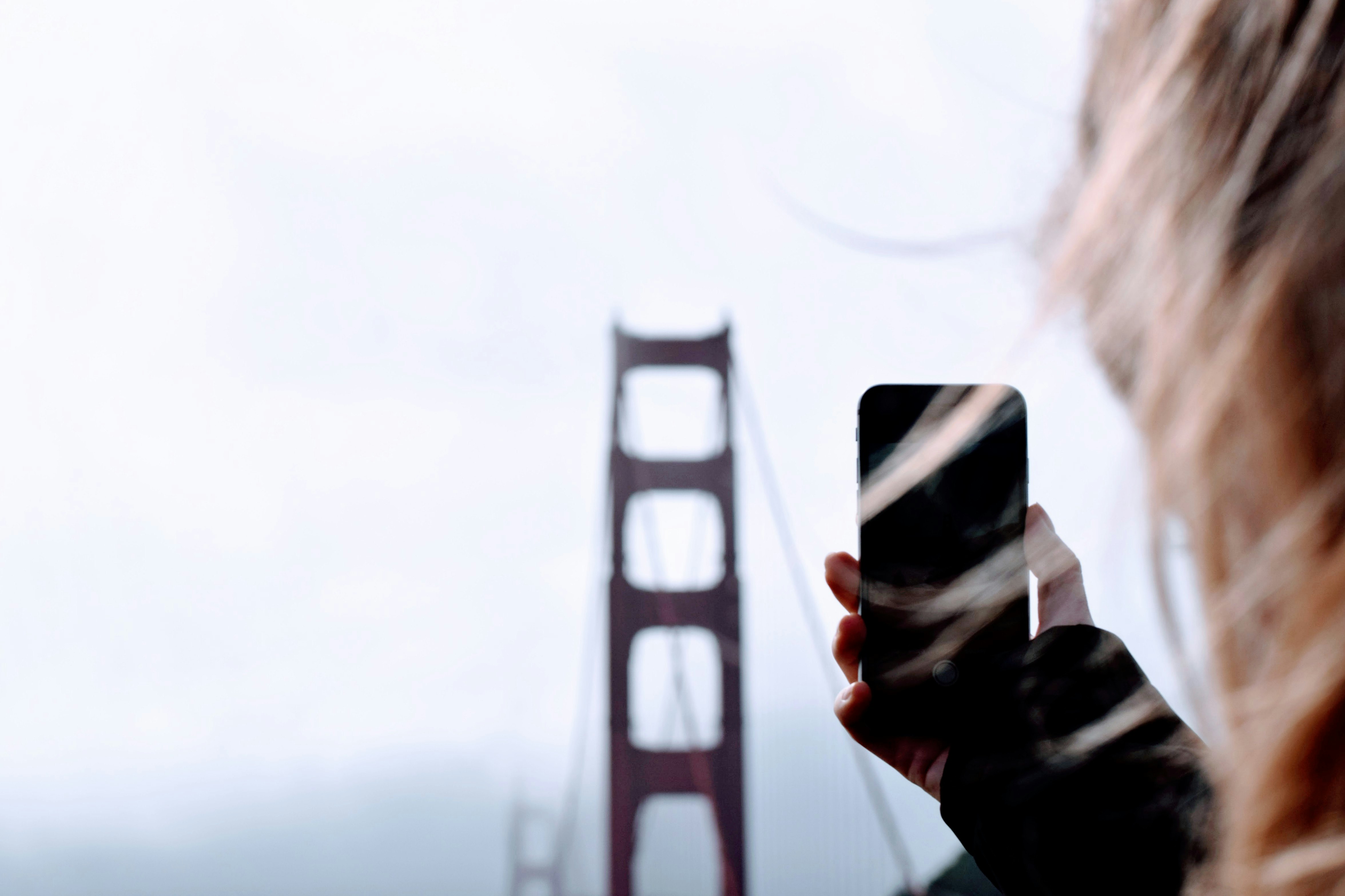 person taking a photo of Golden Gate bridge